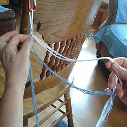 To avoid tangling; each time you pass the strings through, run the fingers of your right hand down the strings in that hand to separate them from the strings in the left